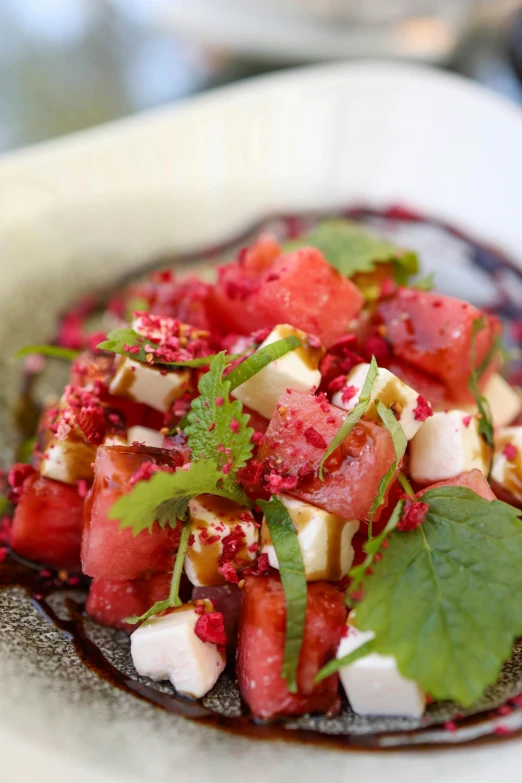 the watermelon salad with garnish on top is ready to be eaten