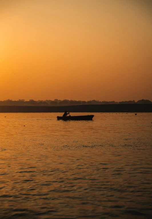 a boat sitting in the middle of a body of water