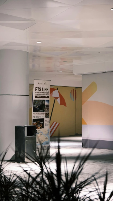 a building with a newspaper holder and large sign