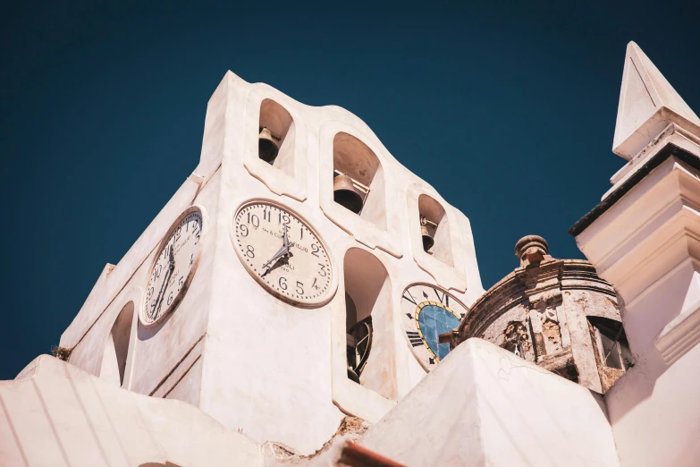 a clock tower with two large clocks on each side of it