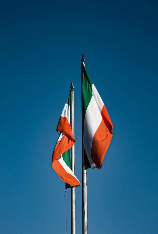 two italian flags are flying beside each other