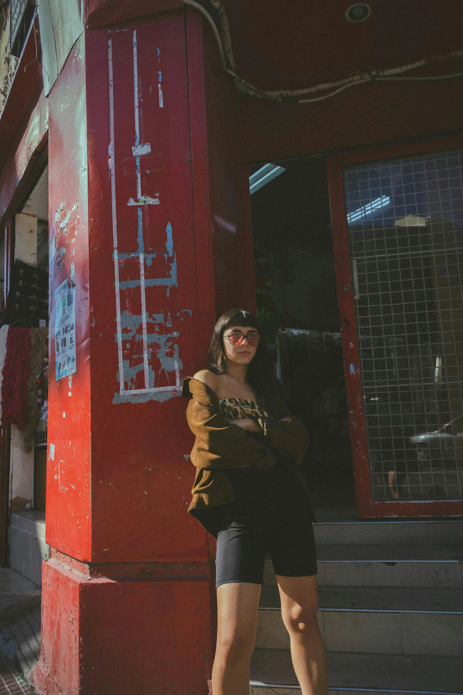 a woman standing on the steps in front of a building