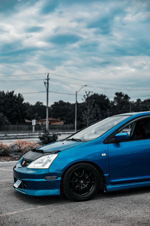 the blue car is parked in the parking lot