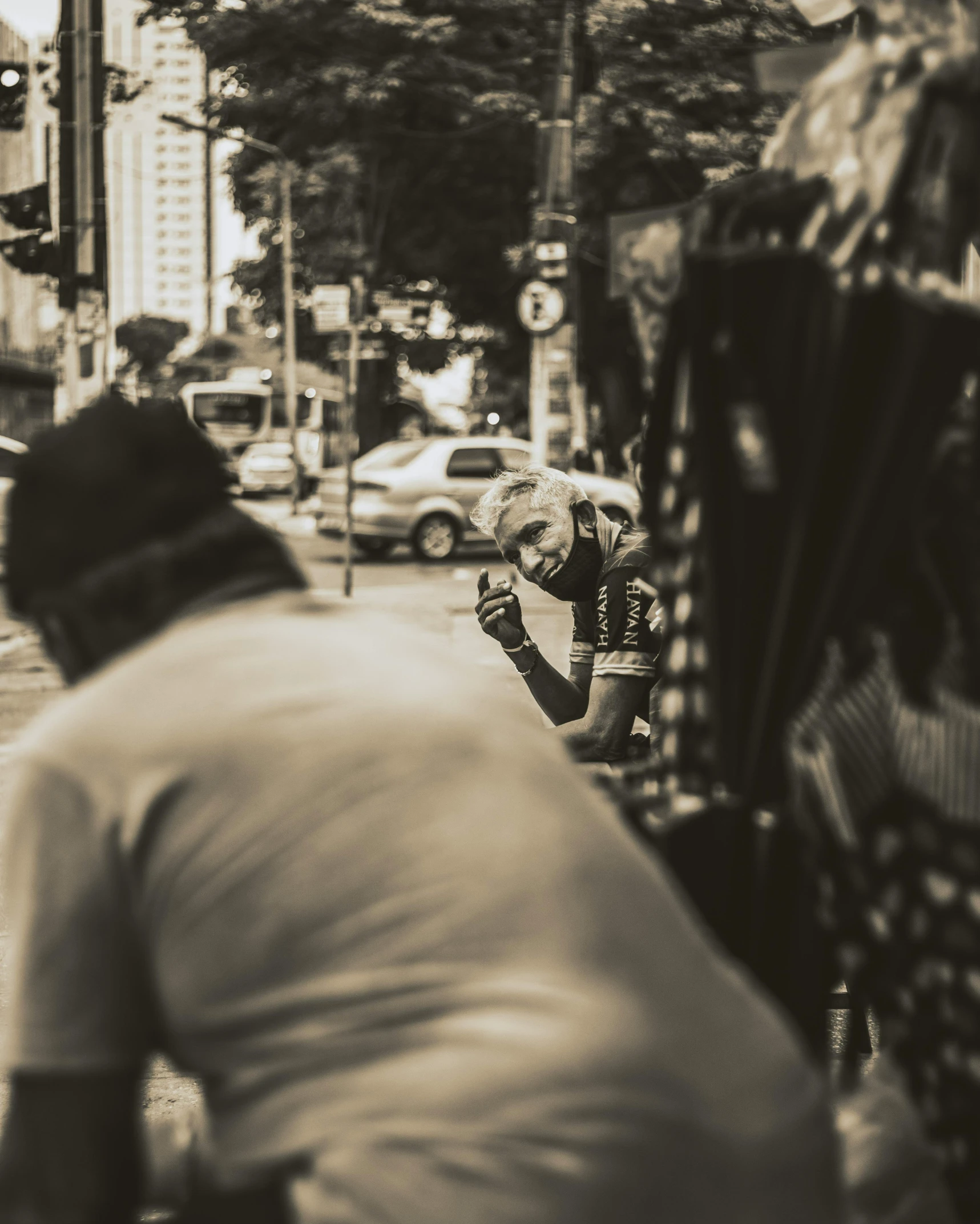 two men walking down a street next to traffic