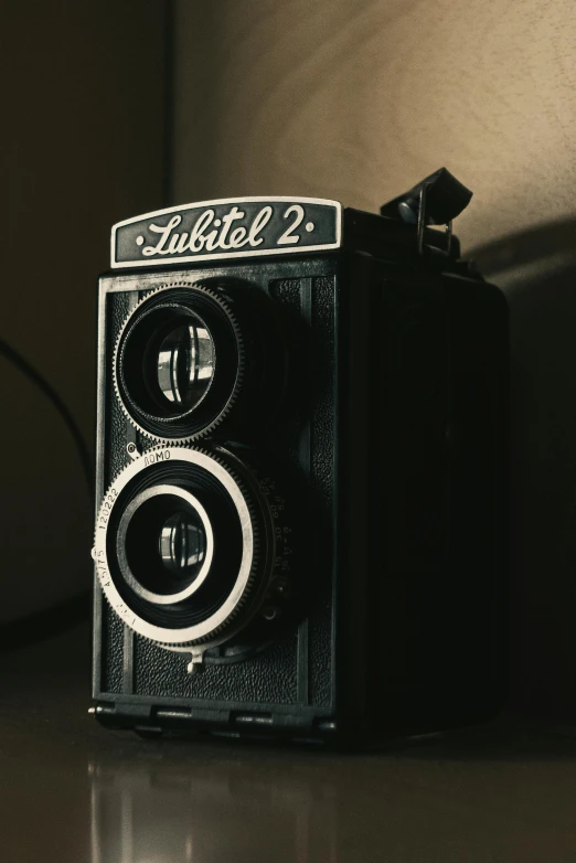 an old black and white camera is on a table