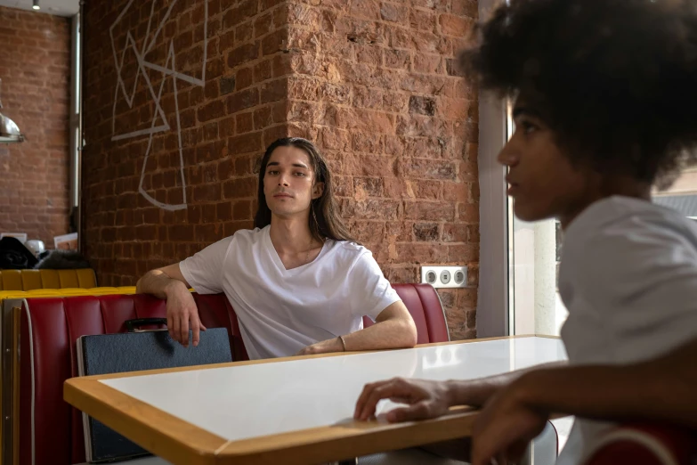 the woman is at a table waiting for someone to return