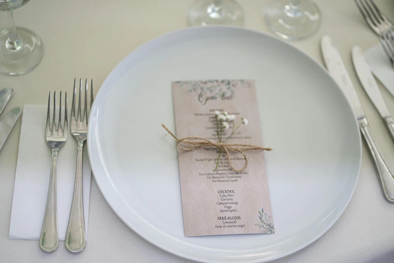 wedding seating card is displayed on a white plate