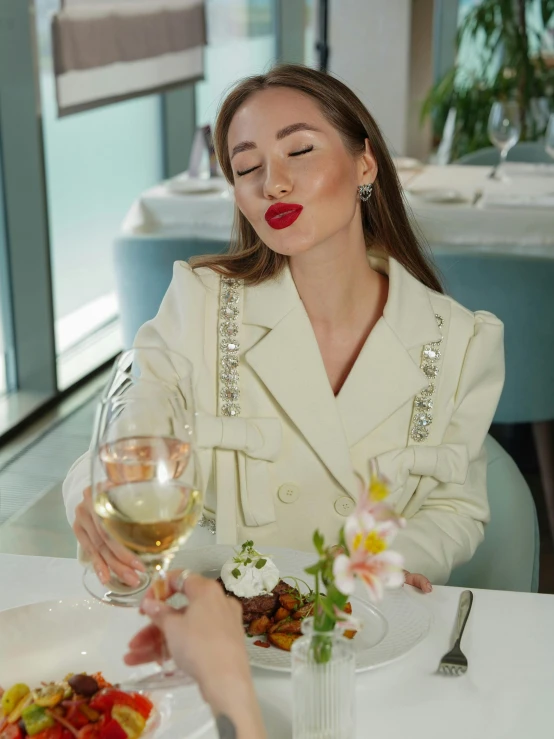 a woman sits down to enjoy her food and drink