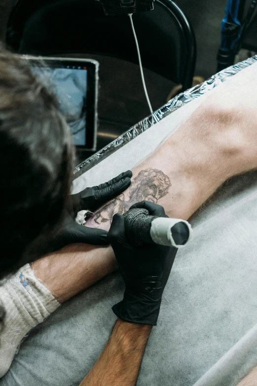 a person is holding a machine and using it to remove a tattoo