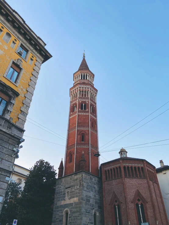 the tall building has a large clock on it's side