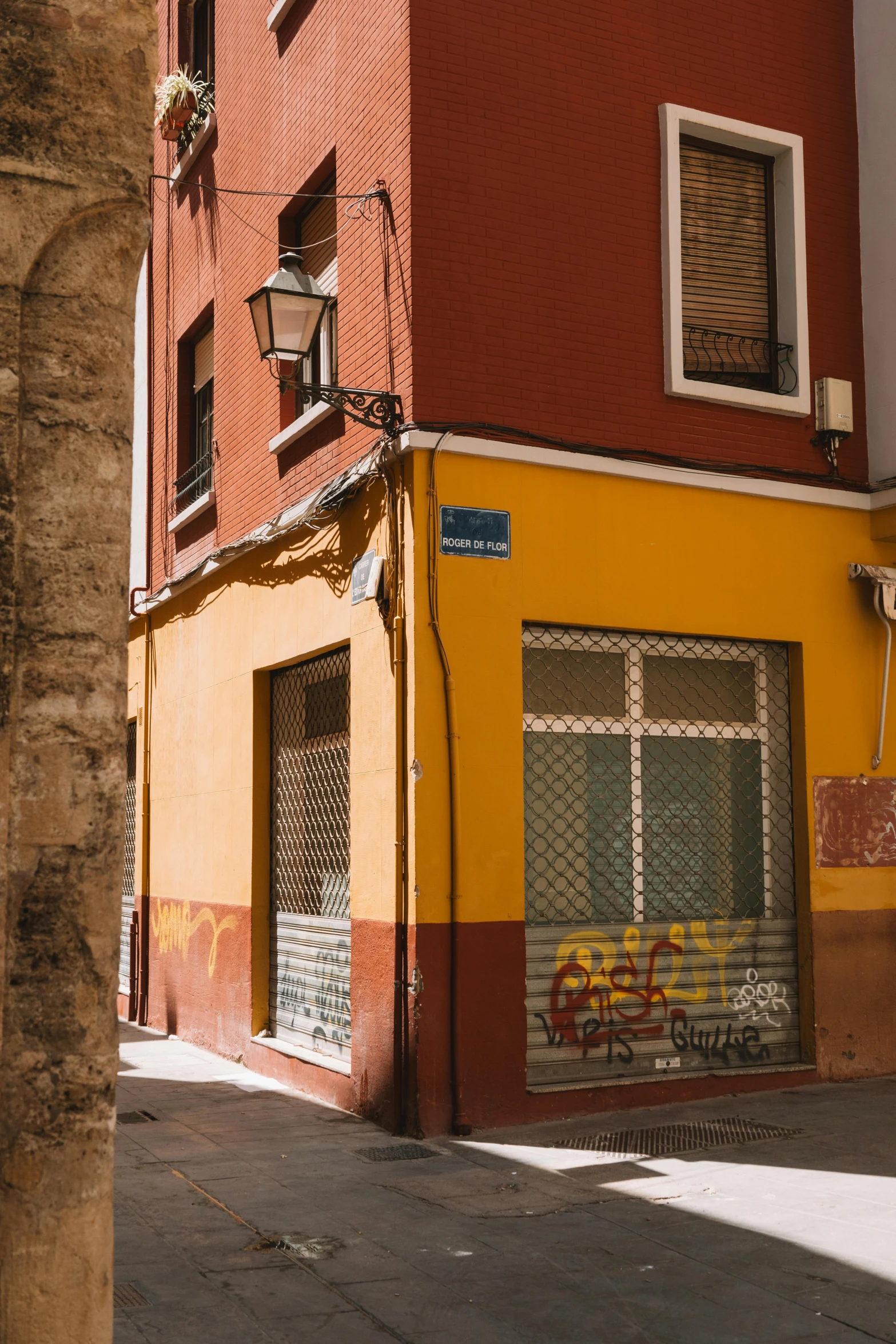 a narrow brick building with a large sign