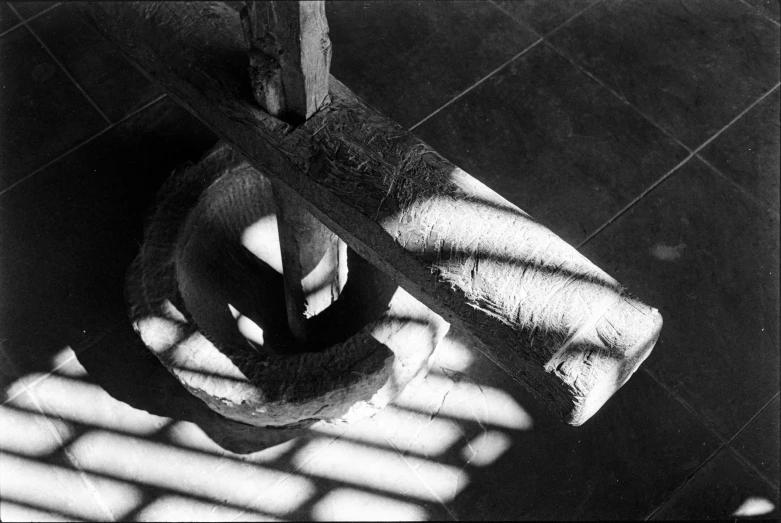 black and white image of a person's hand on top of a tile floor