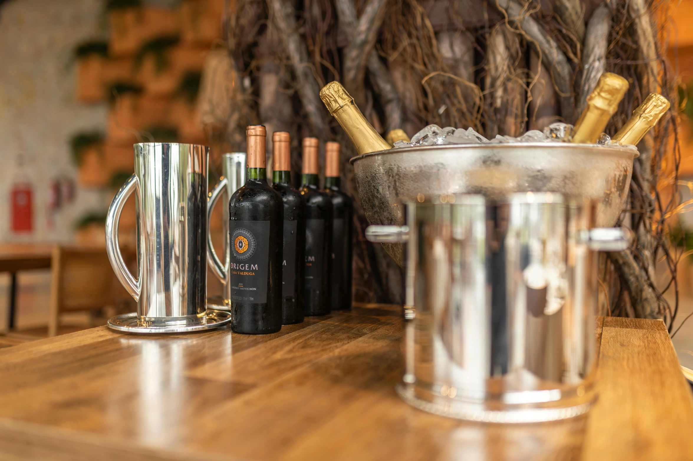 some wine bottles and two glasses on the counter