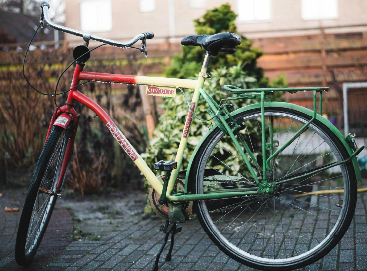 a red and yellow bike is shown in front of a house