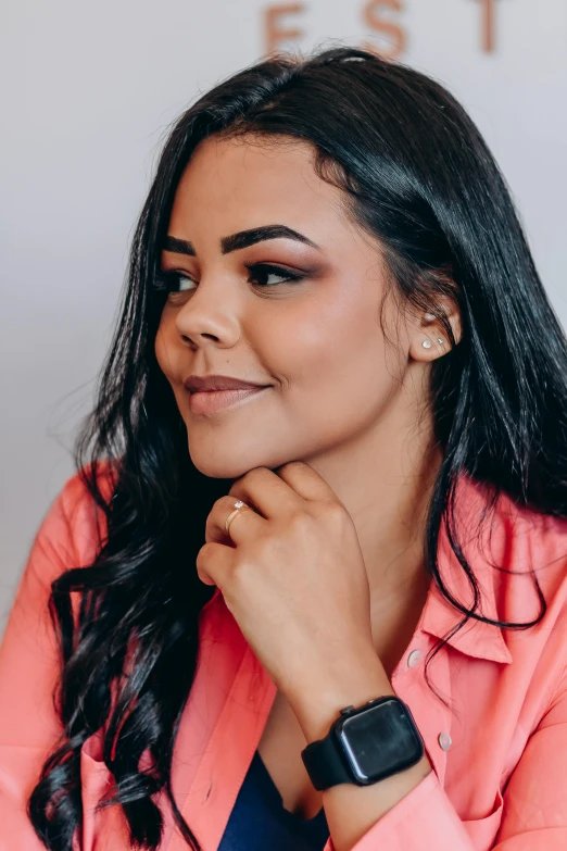 a smiling young lady in a pink coat