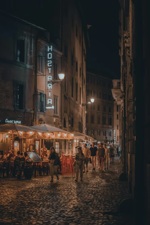 several people walking on an old city street