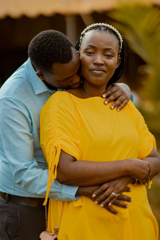 a smiling black couple cuddling while emcing