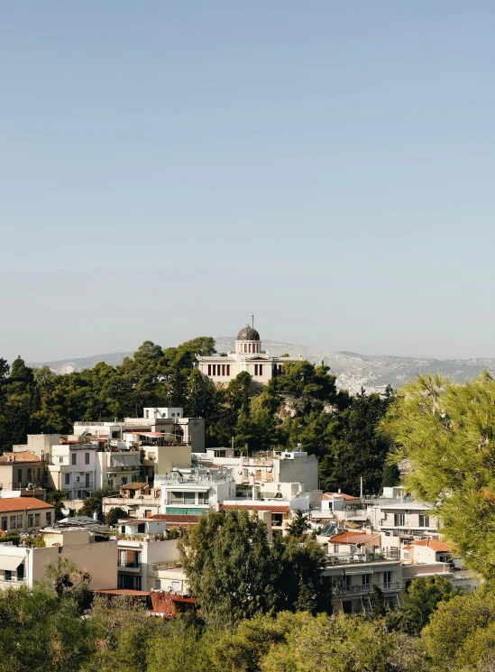 the city is on a hill with buildings in the middle