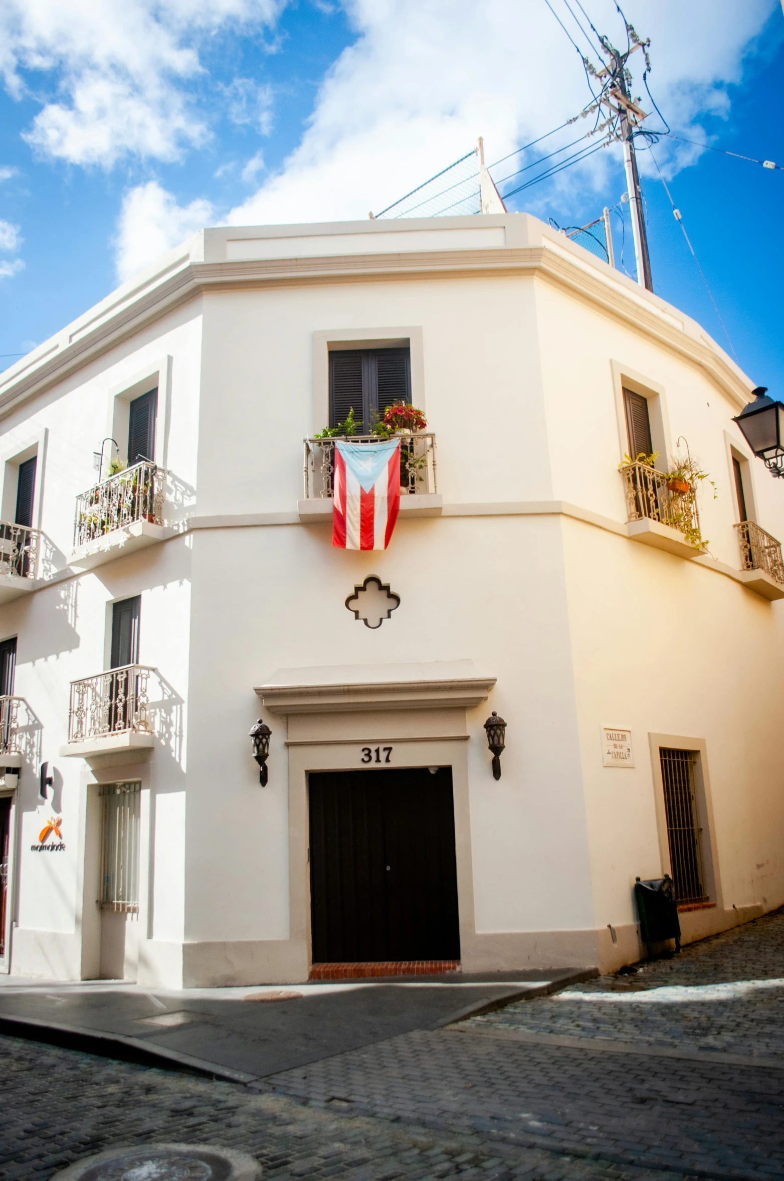 a building with windows with flowers in pots outside