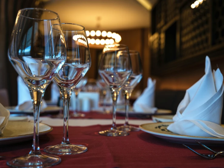 a table with glassware and wine glasses on it