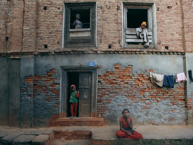 a couple of people standing next to an empty building