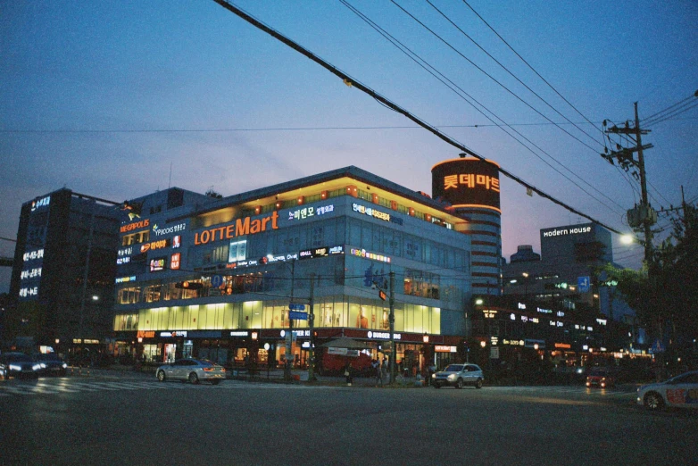 city lights shining at the night time with buildings in the background