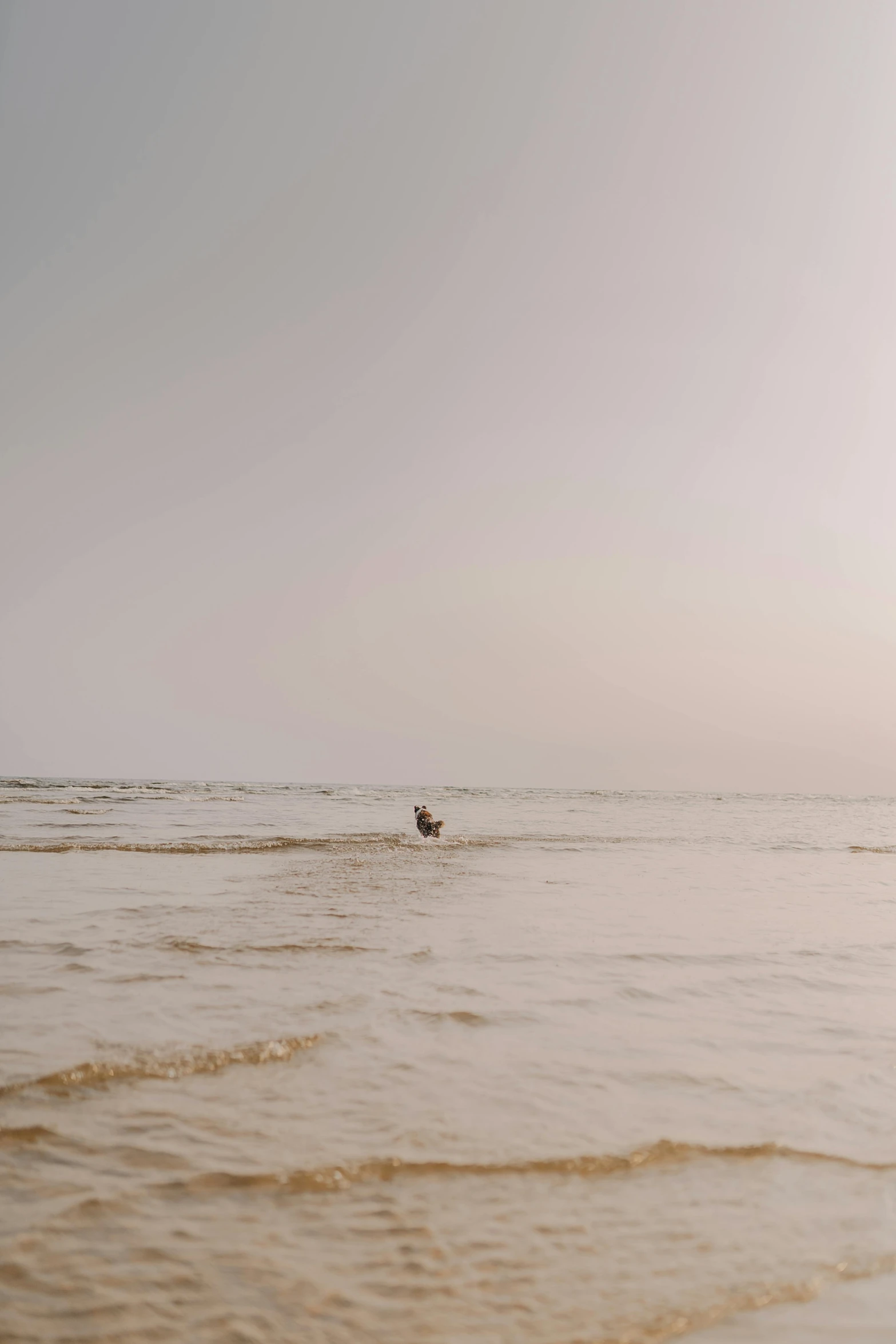 a person that is sitting in some water on their surfboard