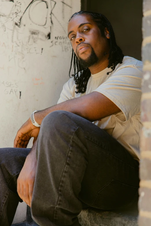 a man is sitting on the steps of a building