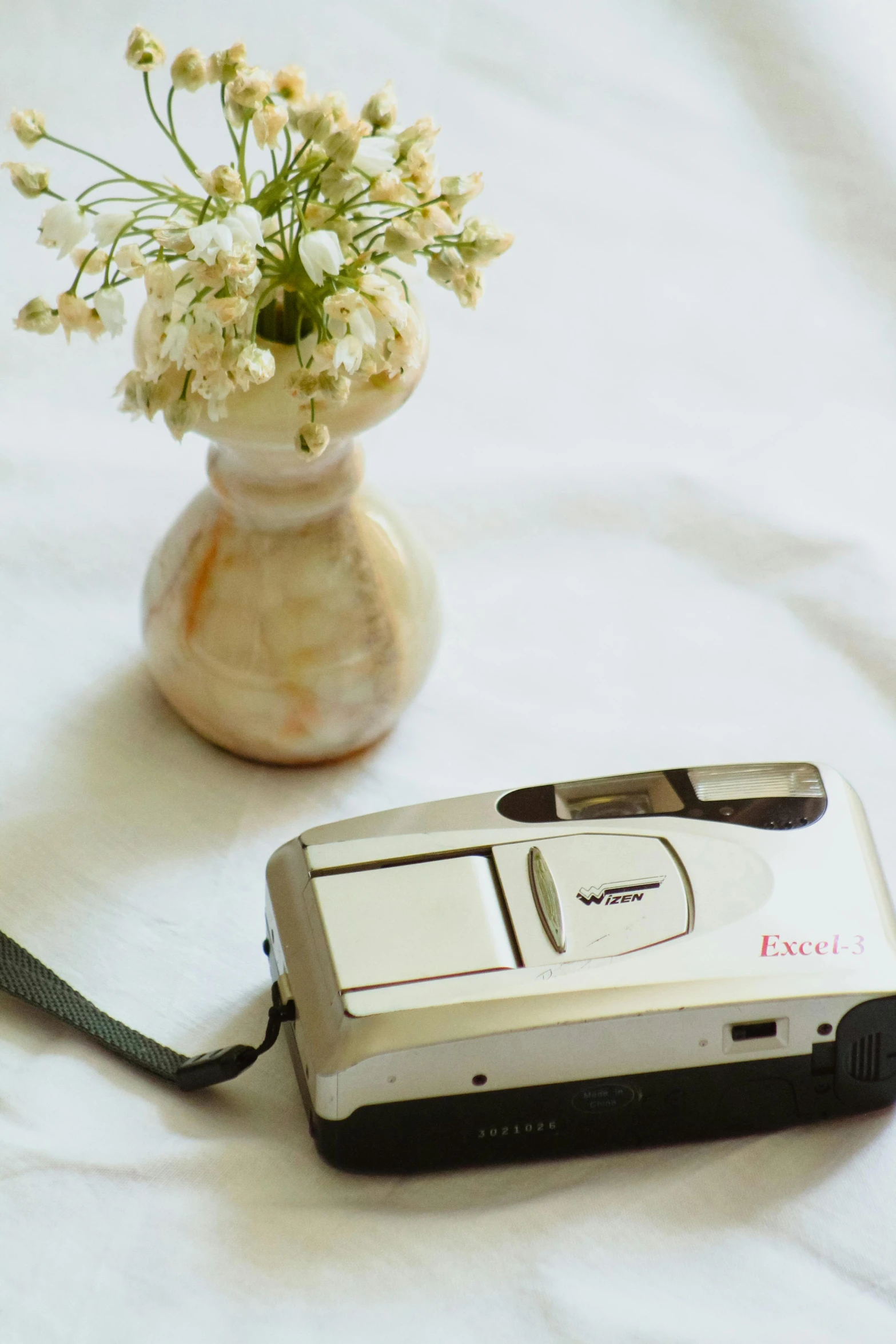 a camera that is sitting next to flowers