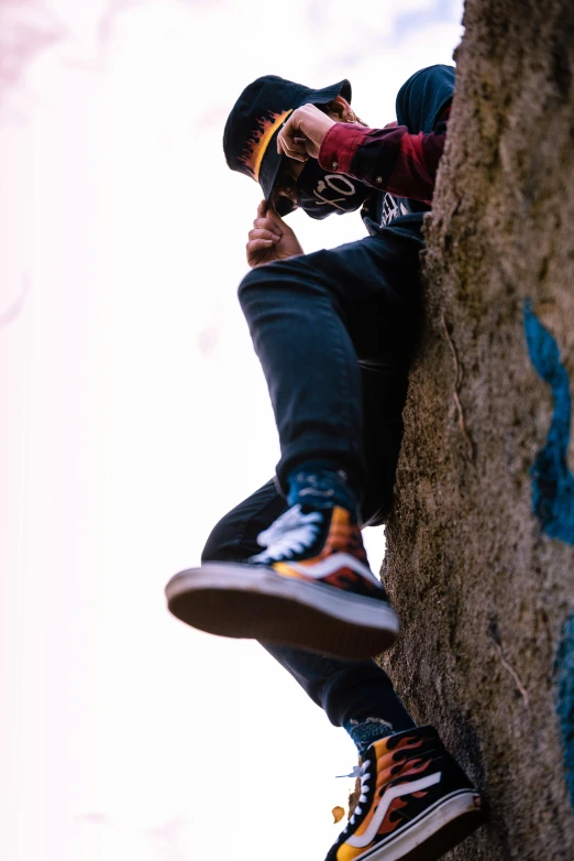 a man on top of a rock with his hands in his pockets