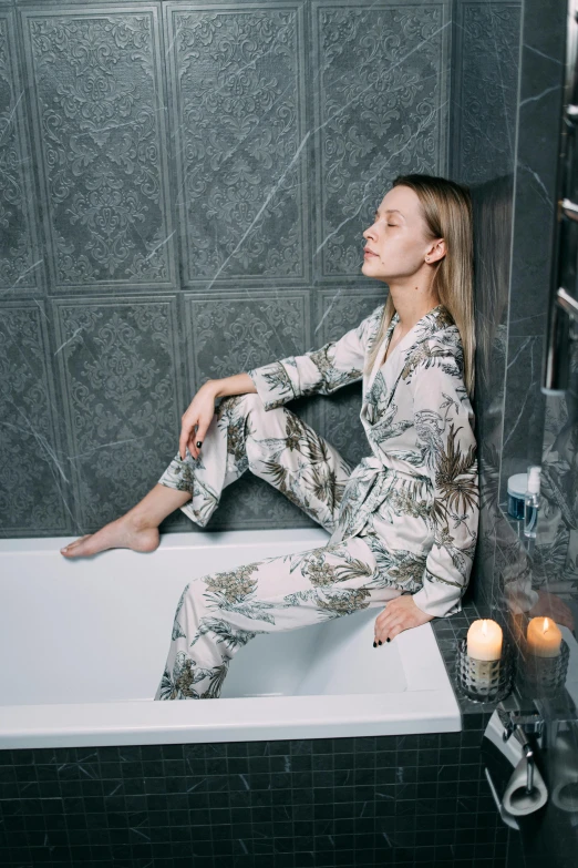 a woman sitting on a bath tub in a bathroom