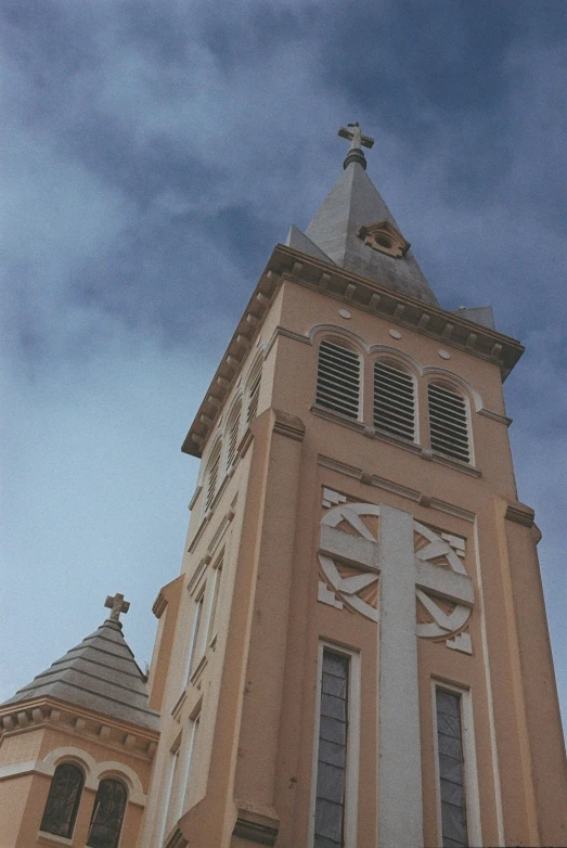 a tall, beige building with a clock on the side