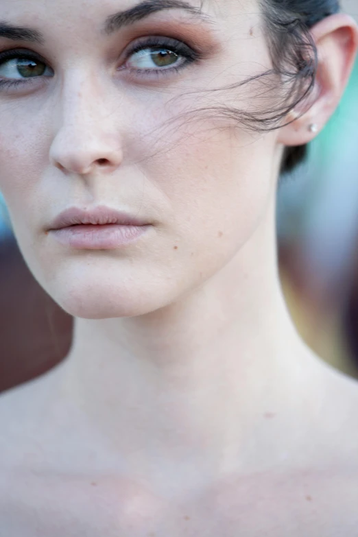 the face of a woman is shown, with very dark hair