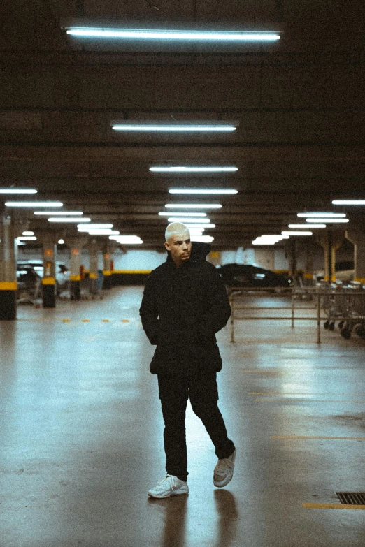 a man standing in a garage in an area that is empty