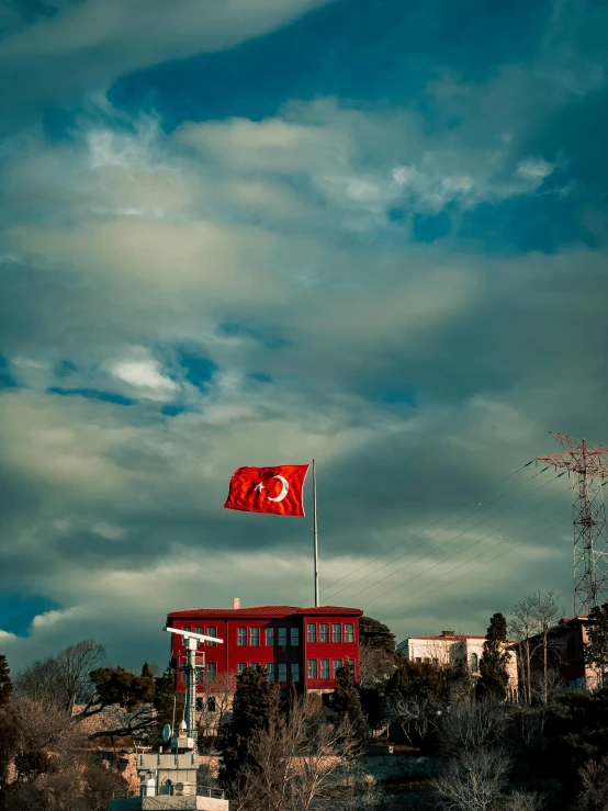 a red and white building on top of a hill