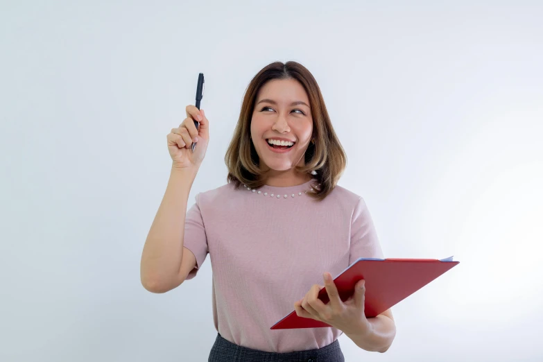 a woman holding a clipboard and writing on it