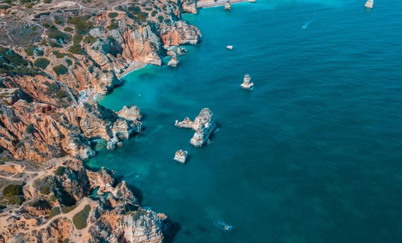 a boat traveling down the sea surrounded by mountains