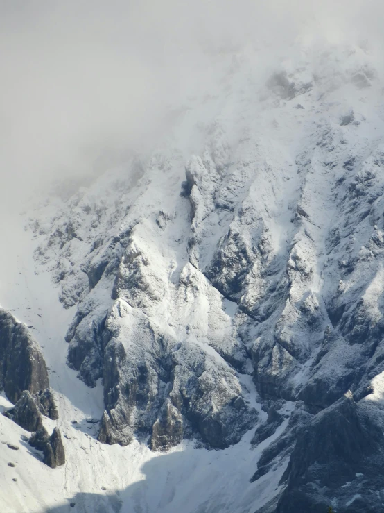 the peak of an impressive mountain covered in snow