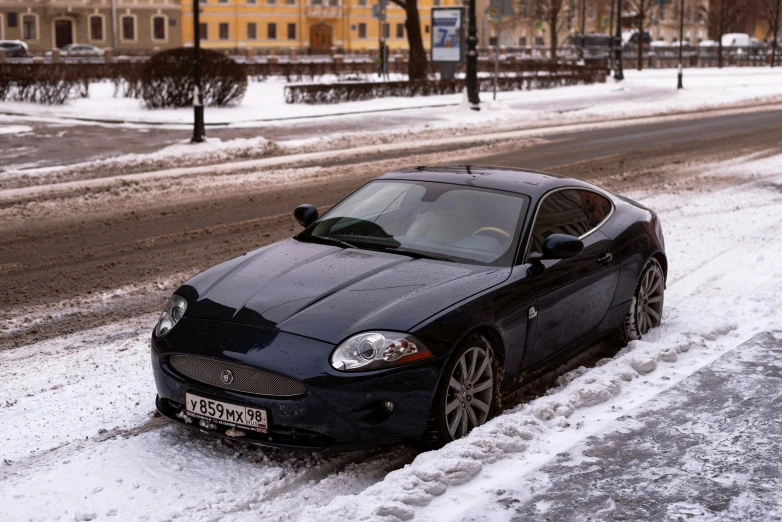 a very parked car parked on a street next to some snow