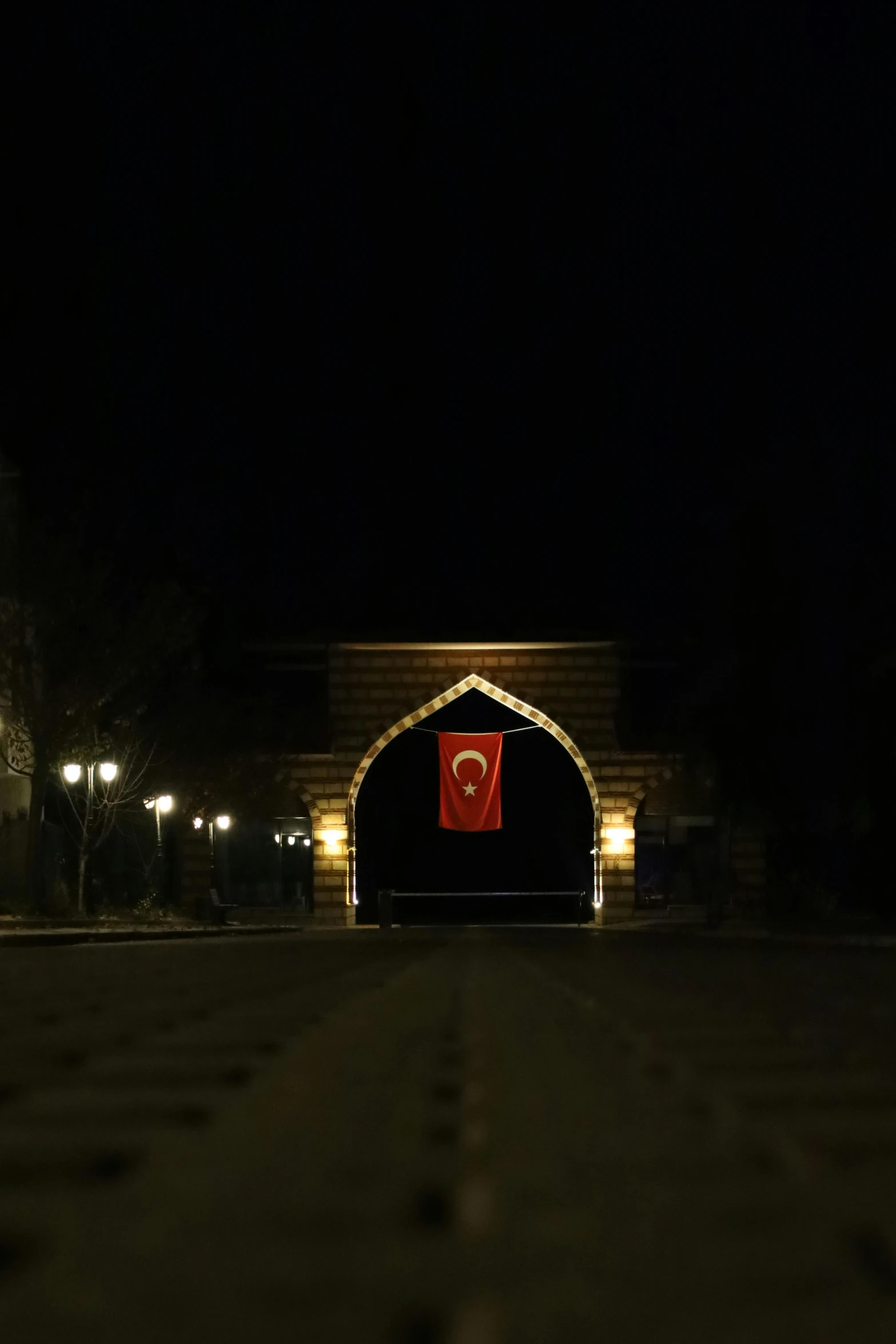 a long building with a red door at night