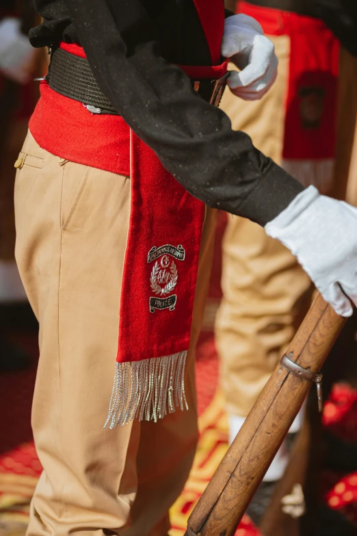 a soldier is wearing uniform and holding a sword