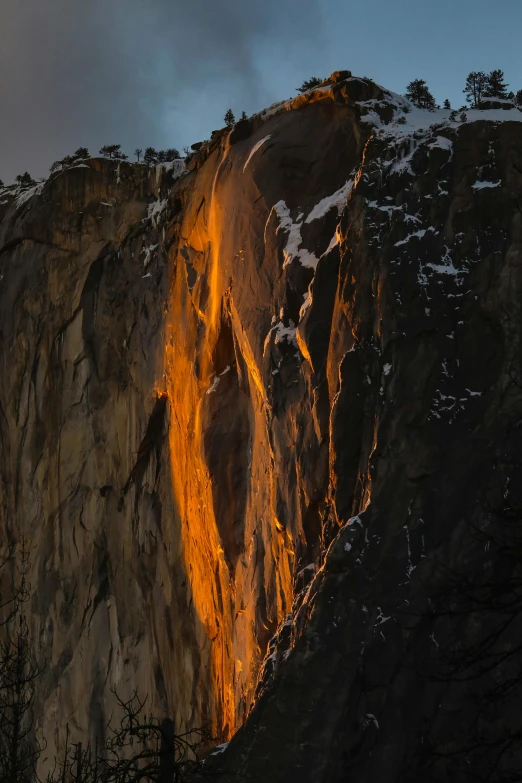 the light from the sun breaks down on the side of a mountain