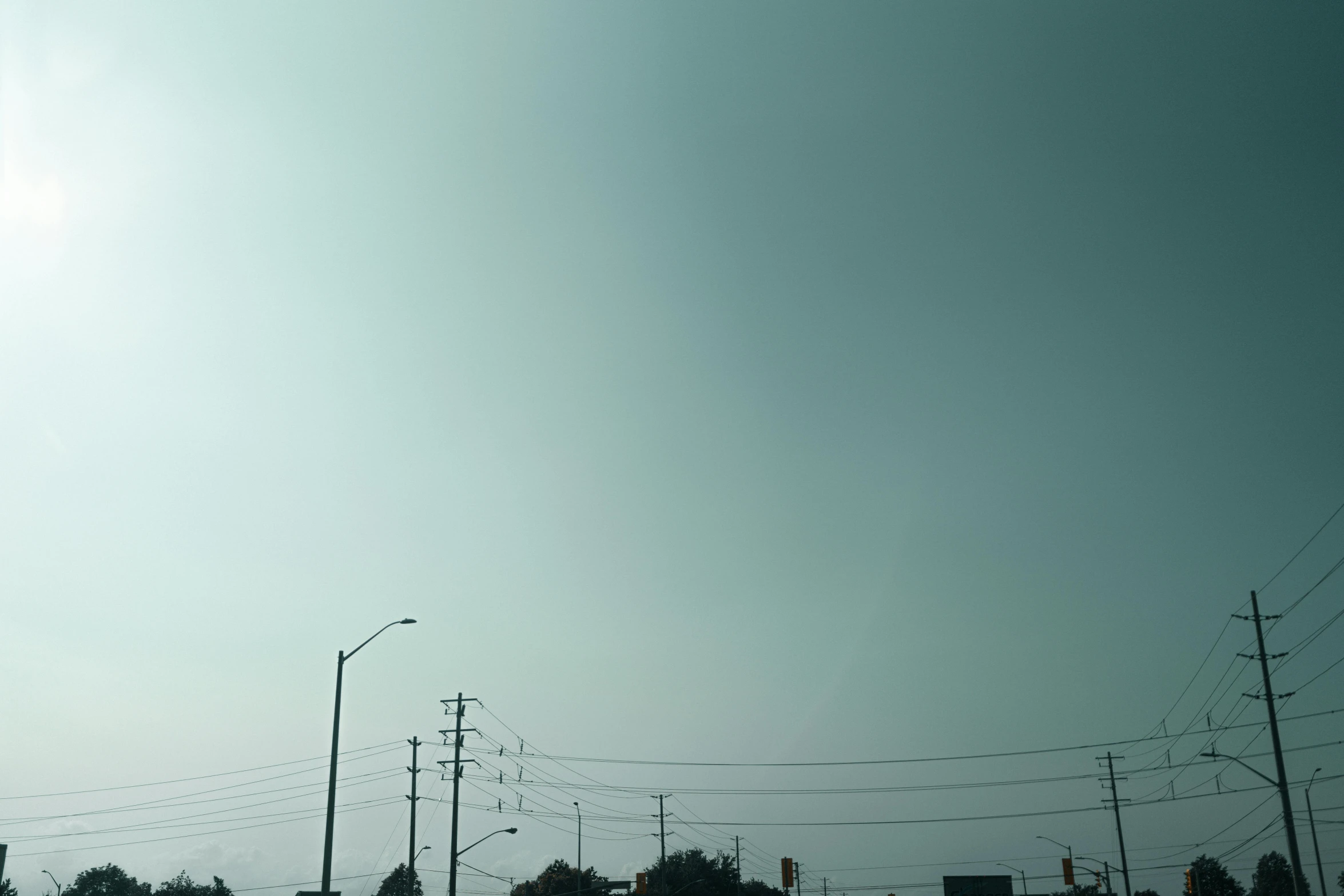 a green street sign against a gray sky