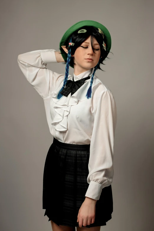 woman dressed in white blouse, black skirt and green hat