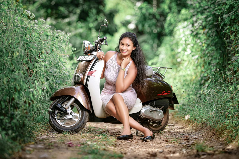 a smiling woman sitting on her scooter, posing for the camera