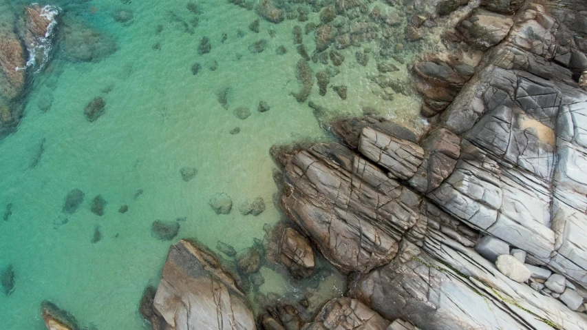 the water is very green and the rocks have been cut out