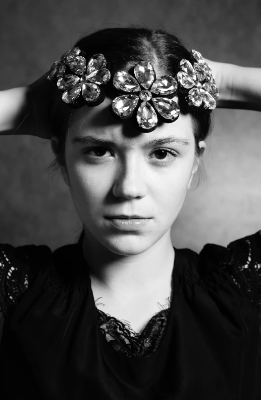 a woman is holding a bunch of flowers in her hair