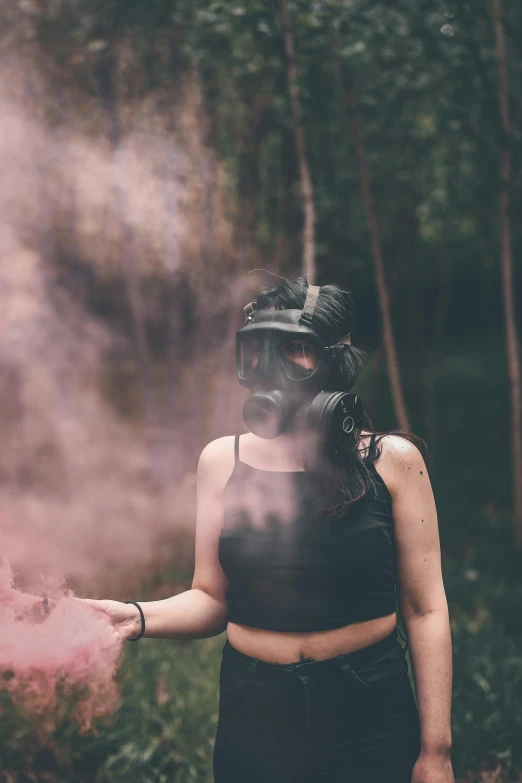 woman wearing gas mask standing in the smoke