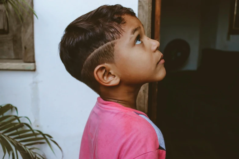 a little boy looking up into the sky