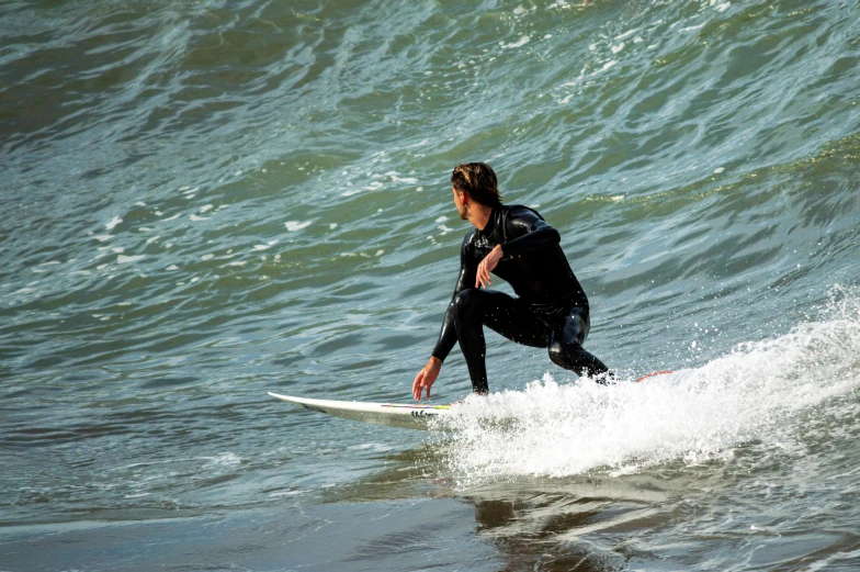 a young surfer is riding the crest of a wave